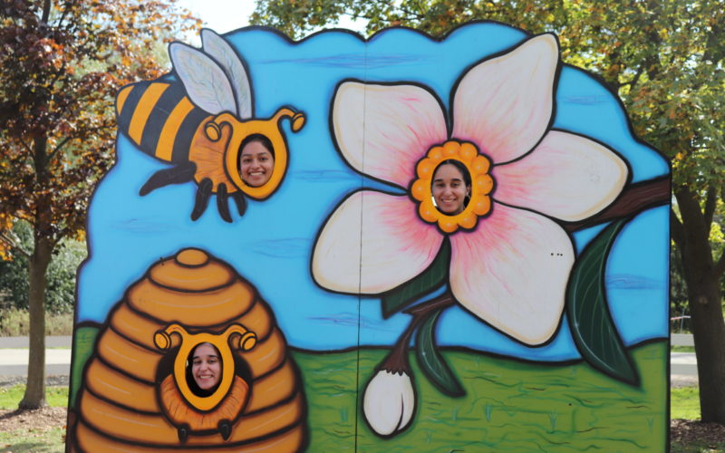 3 people with bee and flower decorations